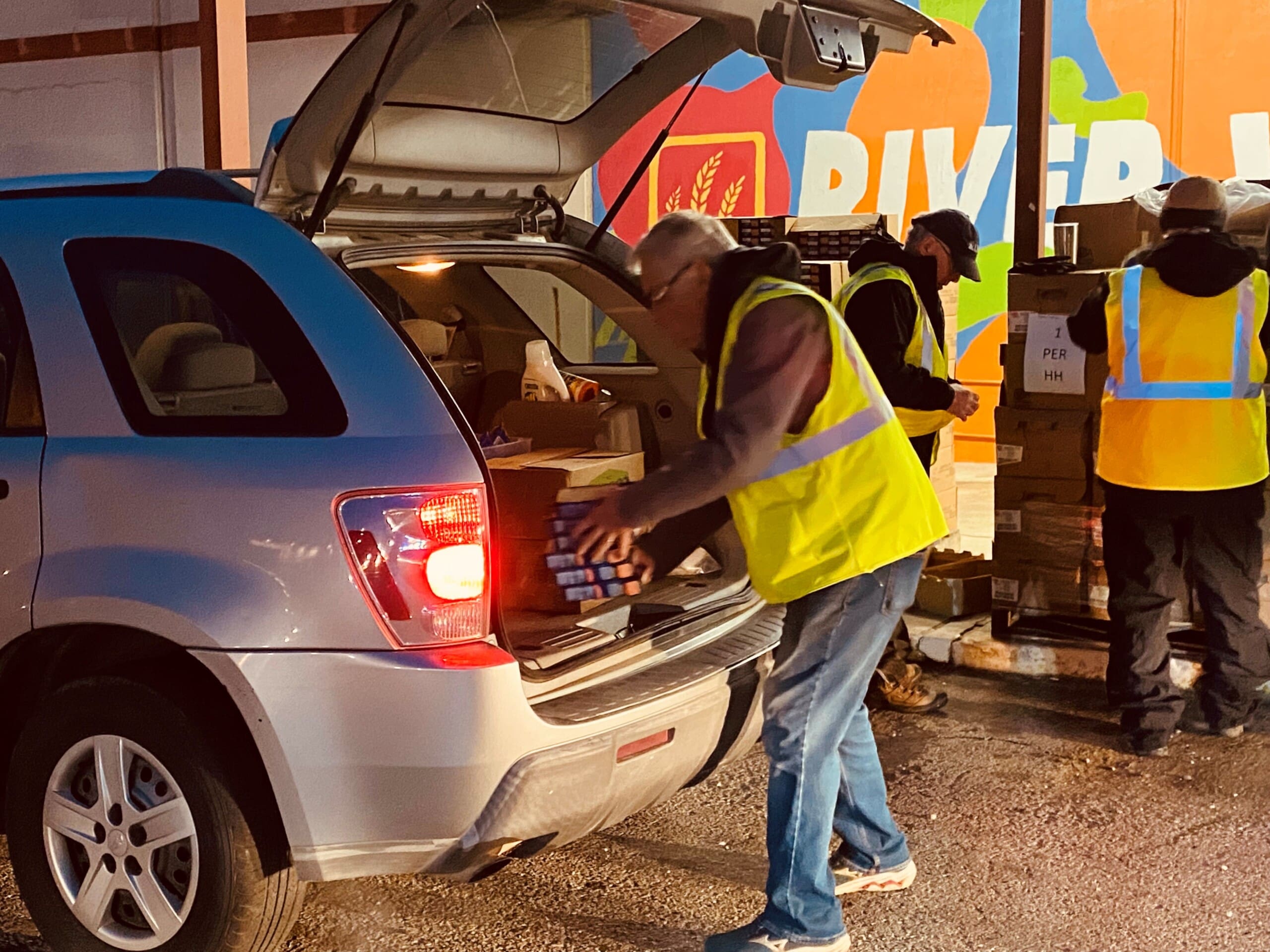 A volunteer loads items into a vehicle at a USDA commodity distribution event in Fort Smith in this undated photo. 